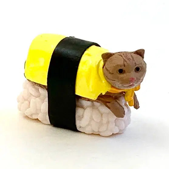 Brown sushi cat sitting on a sushi rice ball.