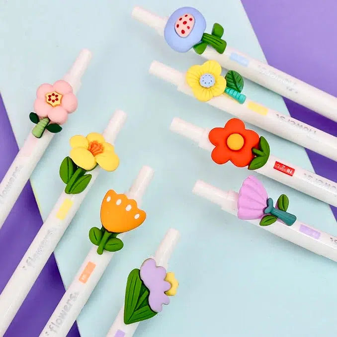 Front view of multiple styles of the flower pens arranged against a purple and blue background.
