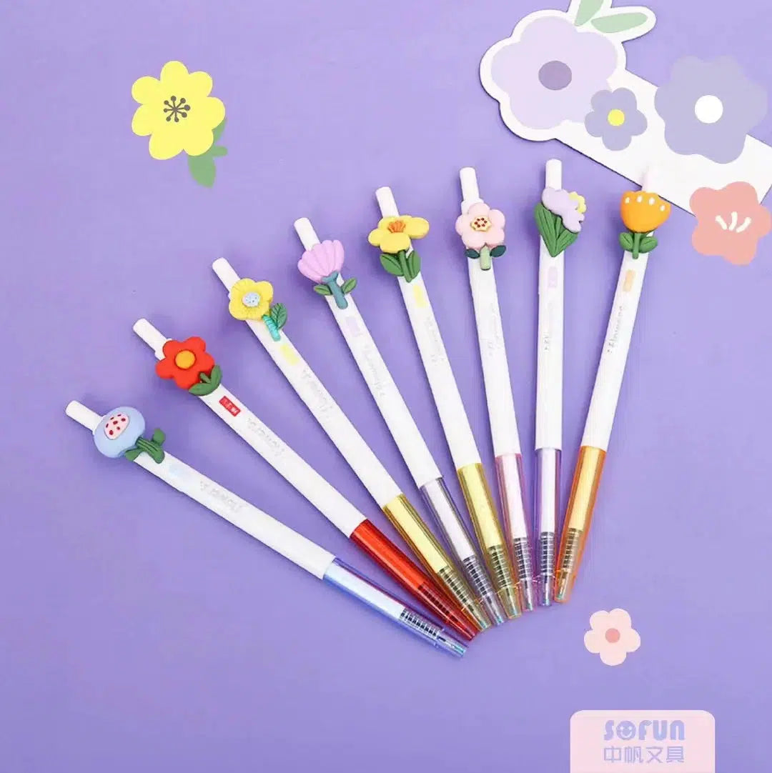 Front view of multiple styles of the flower pens against a purple background.