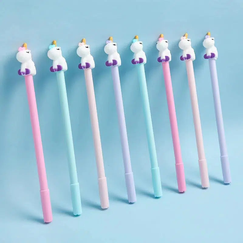 Front view of multiple unicorn pens in assorted styles lined up against a blue background.