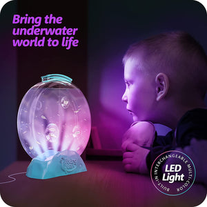 Front view of a poster showing a child in the dark watching the lit up tank from the Hydropets Live Sea Pets Habitat Kit, Light Up Tank.