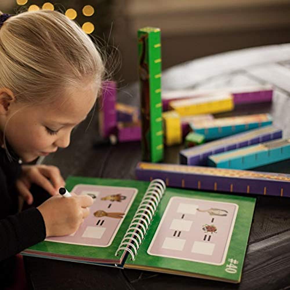 side view of child doing math in book