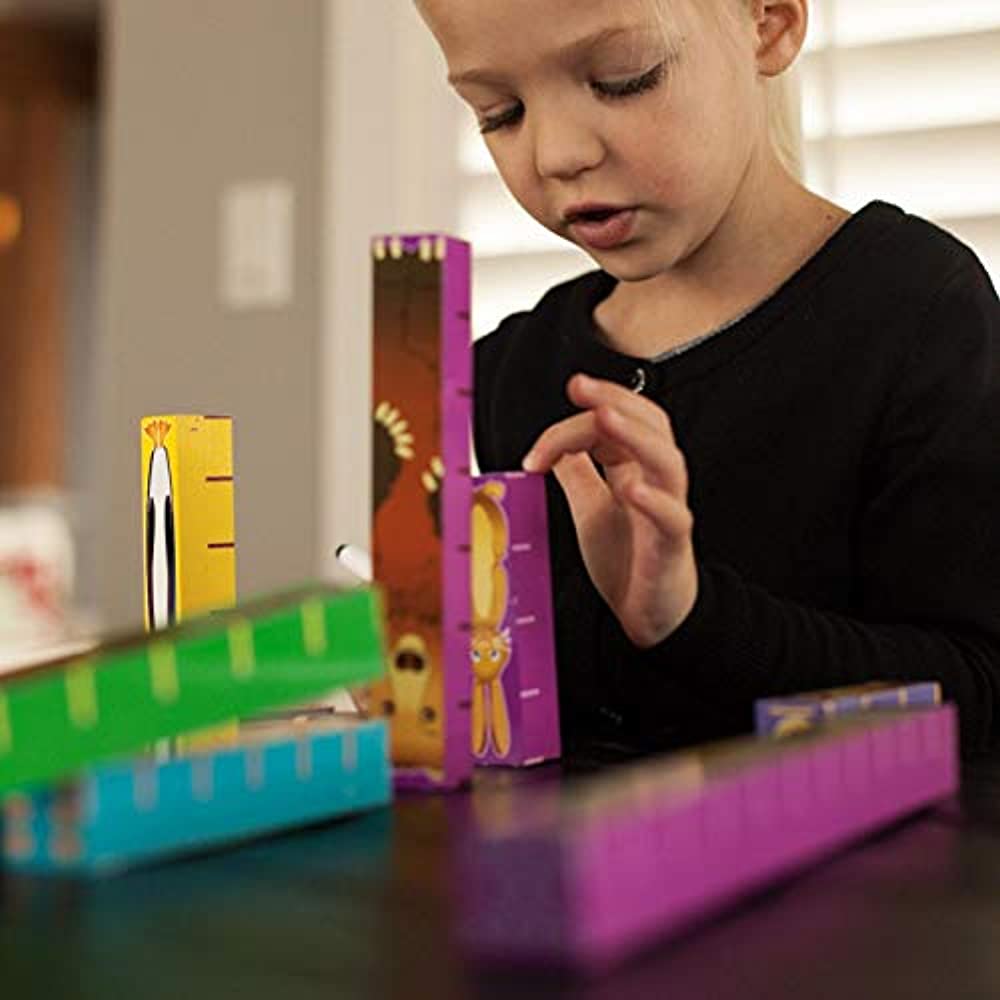 child playing with inchimal animals