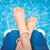 Front view of a two fingers on a raft in a pool with the Finger Puppet-Finger Feet on the fingers.