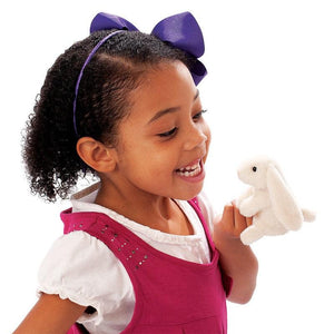 Front view of a little girl holding a Mini Lop Rabbit puppet on her finger.