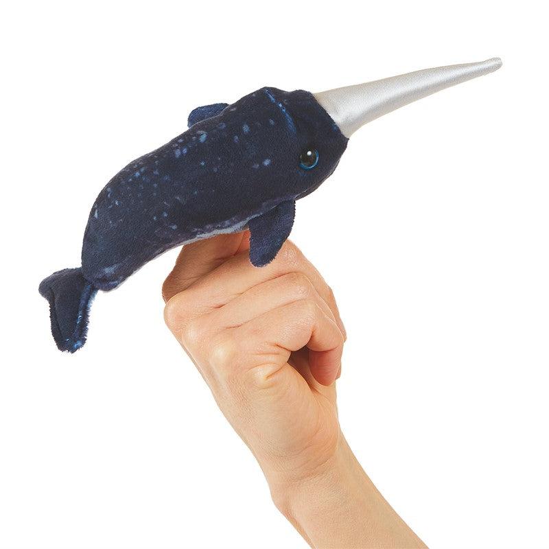 Front view of a mini narwhal finger puppet on a person&#39;s finger.