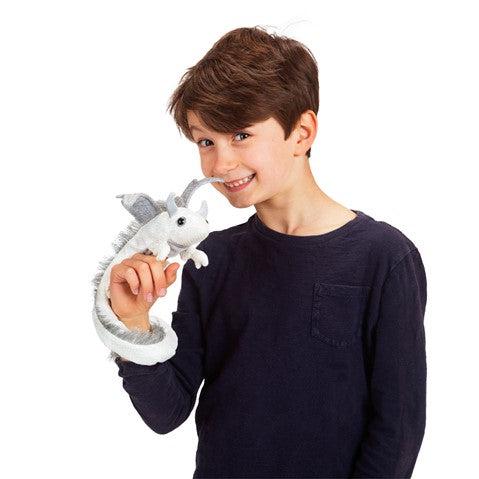 Front view of a child using the pearl dragon wristlet puppet. 