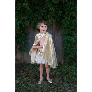 Front view of a child in the Gracious Gold Sequin Cape.