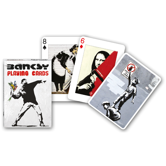 Front view of Banksy Playing Cards in its box and various cards beside it.
