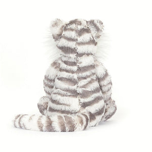 Rear view of bashful snow tiger sitting down against a white background.