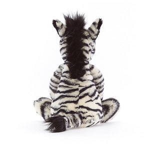Rear view of bashful zebra sitting down.