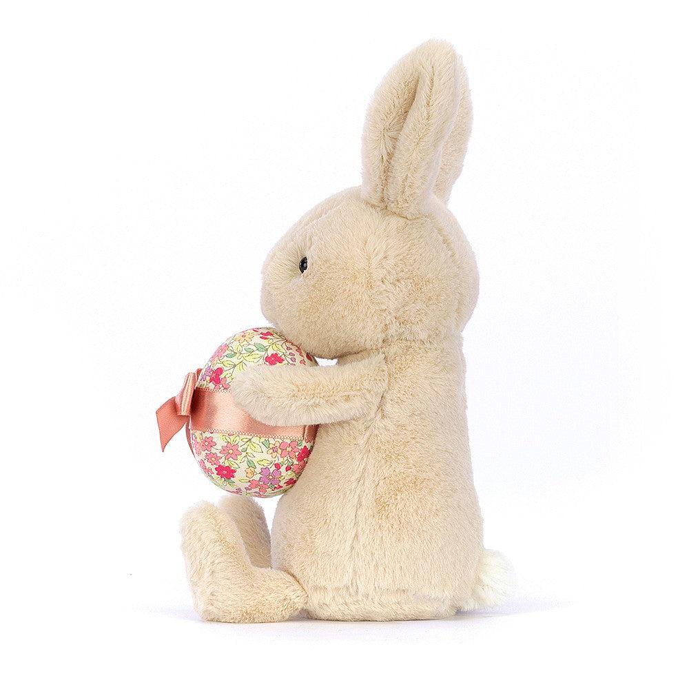 Front side view of Bonnie Bunny With Egg showing bunny holding the egg.
