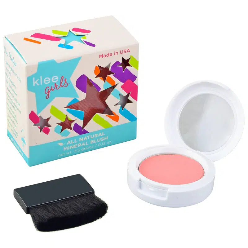 Front view of Klee Hampton Buzz Blush in packaging with an open compact and blush brush beside it.