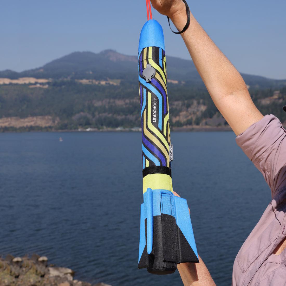 Front view of a person holding up inflated blue Airo Rocket.
