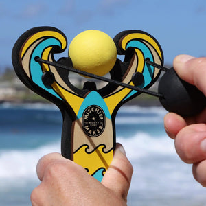 Front view of hands cocking the yellow mischief maker slingshot.