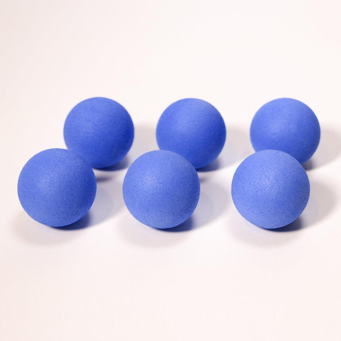 Front view of six blue mischief maker refill balls lined up in two rows.