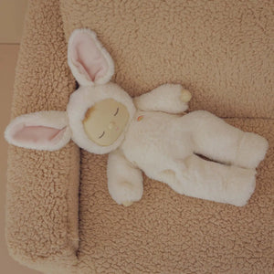 Front view of the Bunny Moppet Doll laying on an armchair.
