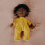 Front view of a doll laying down with Honey PJs on.