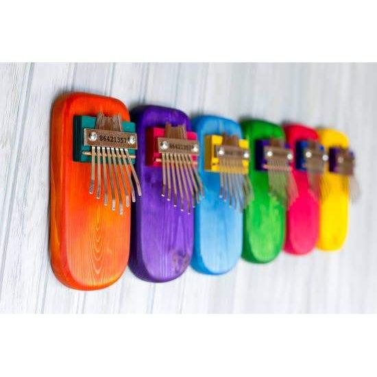 Front view of the Pine Kalimbas showing the colors orange, purple, blue, green, pink, and yellow.