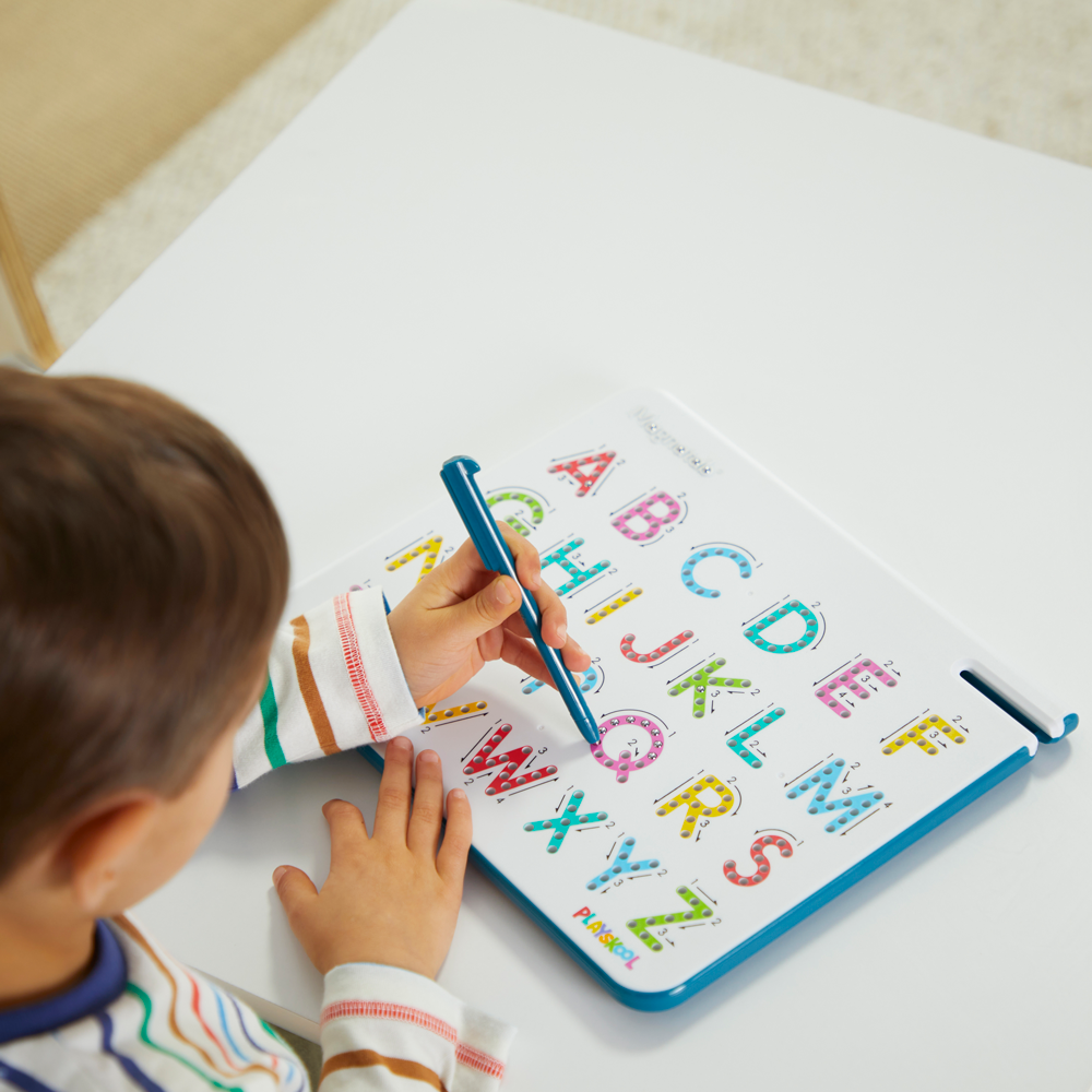Front overhead view of a small child tracing their letters on the Magnatab A to Z Uppercase board.