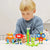 Front view of a young boy playing with 5 assembled Plus Plus Learn to Build Creatures.