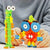 Front view of a child's hands playing with two assembled Plus Plus Learn to Build Creatures.