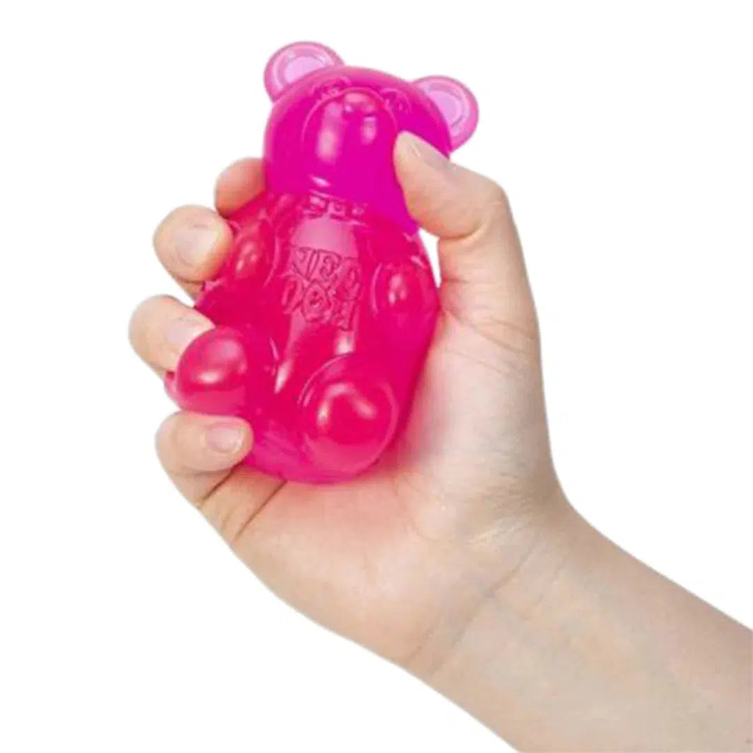 Front view of a person holding the pink Nee Doh Gummy Bear in their hand.