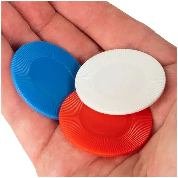 Front view of a person&#39;s hand holding a red, white, and blue poker chip in their hand.