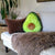 Front view of the Comfort Food Avocado sitting on a sofa.