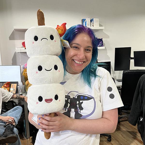 Front view of a woman holding the Comfort Food Marshmallow up.