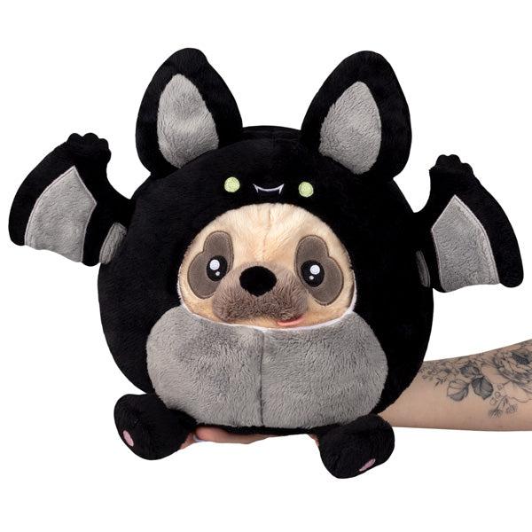 Front view of a Undercover Pug in Bat being held in a persons hand in costume.