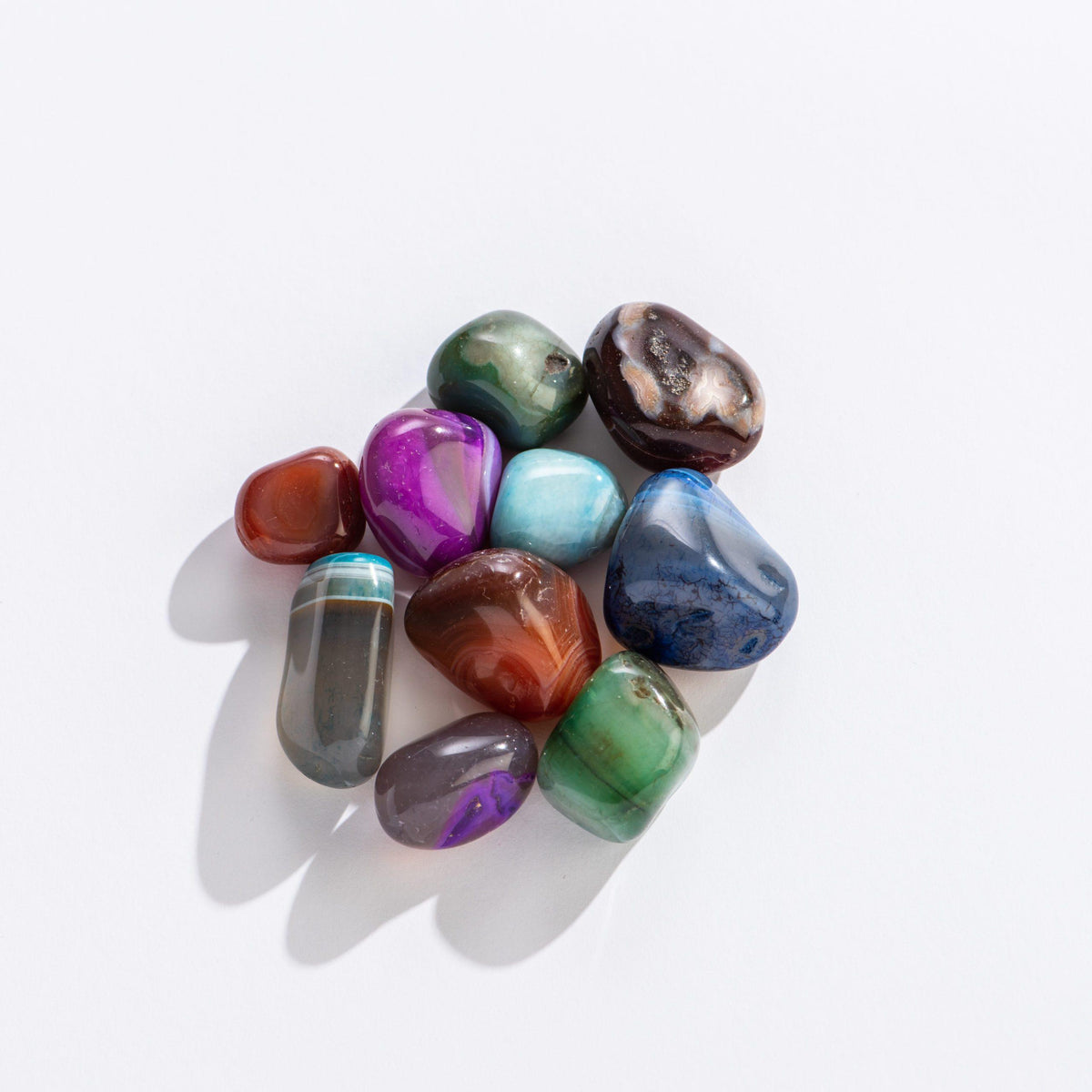 Front view of a variety of rocks in the gem colors from the Fill-A-Pouch-Rock Treasure Bag.