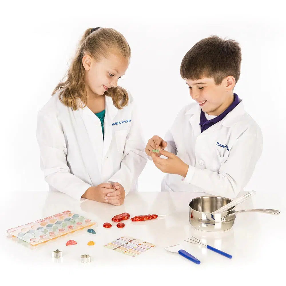 Front view of 2 children using the candy chemistry set.