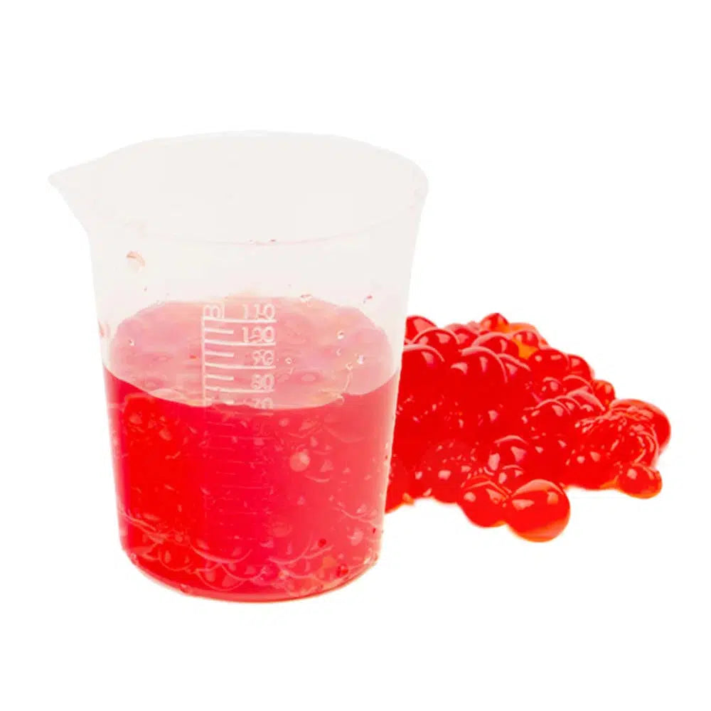 Front view of the mixing container with the watermelon juice beads in it and beside it from the Chemistreats! Candy + Chemistry set.