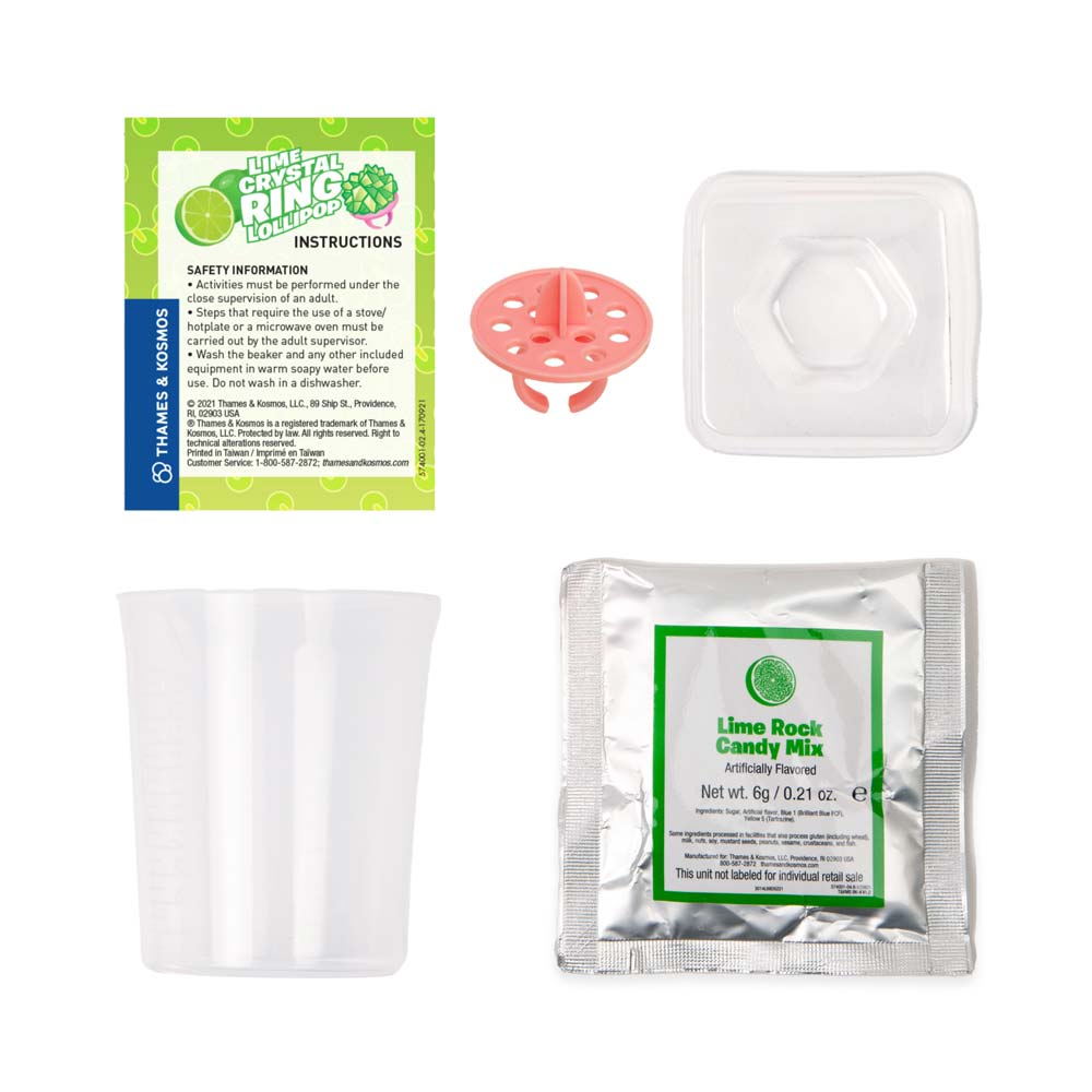 Front view of the instructions, ring base, mold, mixing container and ingredients from the lime crystal ring lollipop Chemistreats! Candy + Chemistry set.