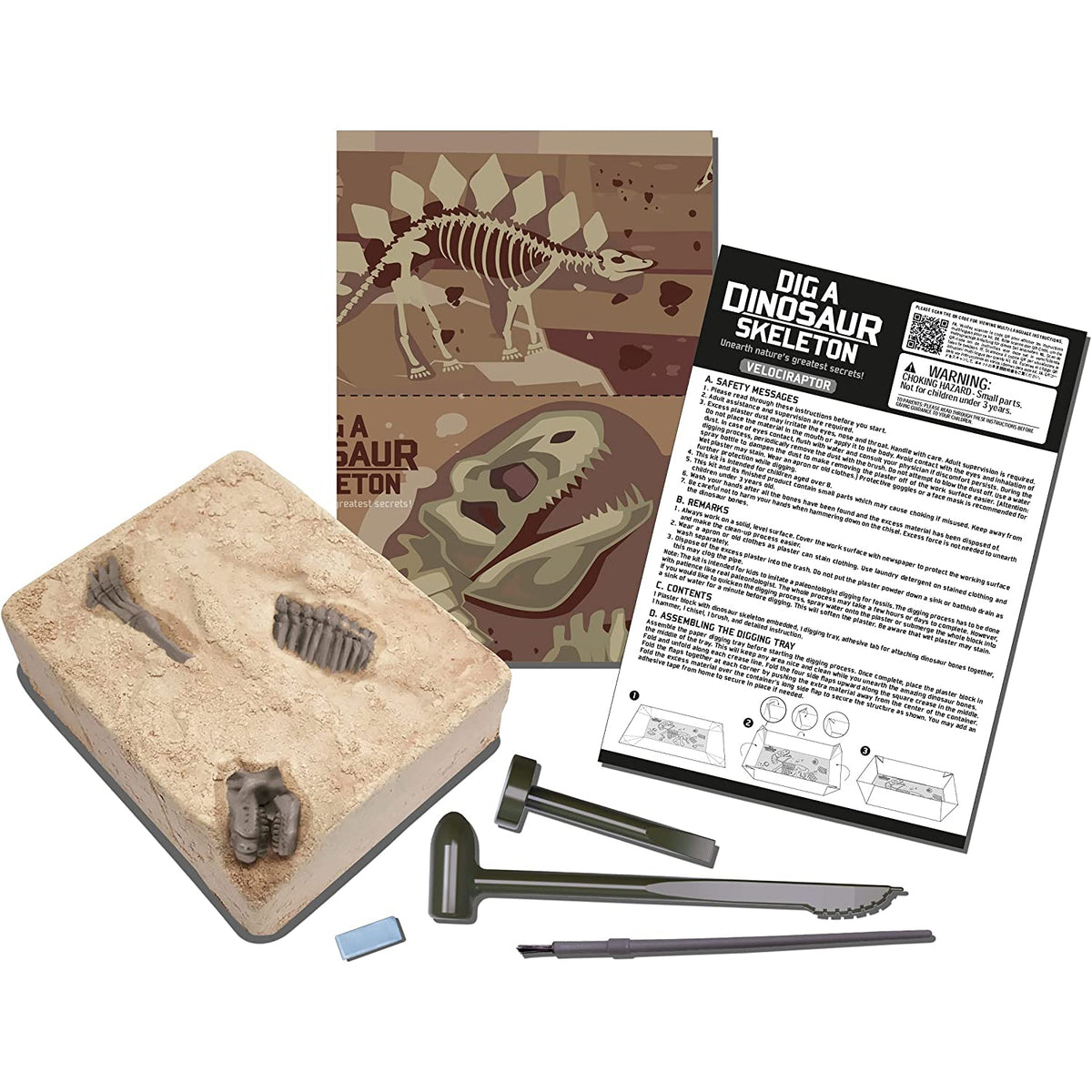 Front view of contents of Dig A Dinosaur Skeleton Velociraptor showing tools, directions, the plaster block, and paper digging tray.