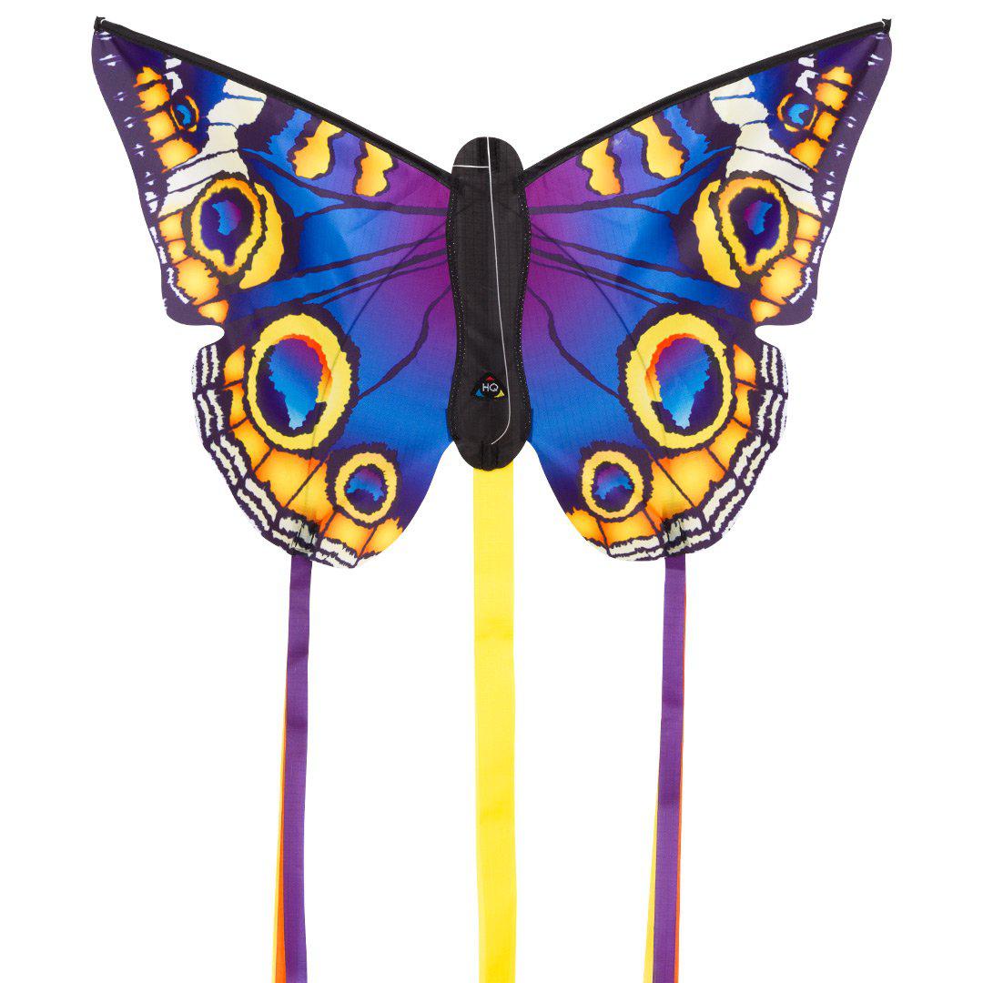 Beautiful blue, purple, and yellow butterfly kite with purple and yellow tails, against a white background.