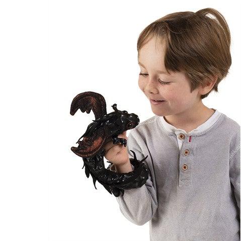 Winged dragon wristlet perched on a smiling child&#39;s hand