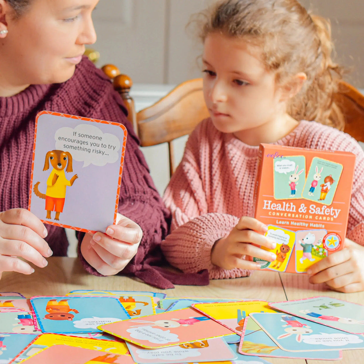 Front view of a woman and a child using Health &amp; Safety Conversation Cards.