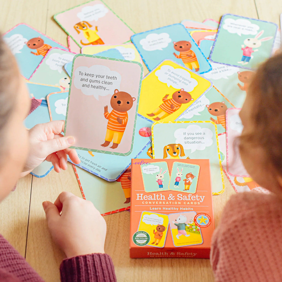 Rear view of a woman and child using Health &amp; Safety Conversation Cards.
