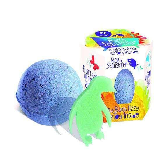 Front view of the blue Bath Squiggler-Single Bath Bomb Surprise sitting beside with the package and the surprise beside it.