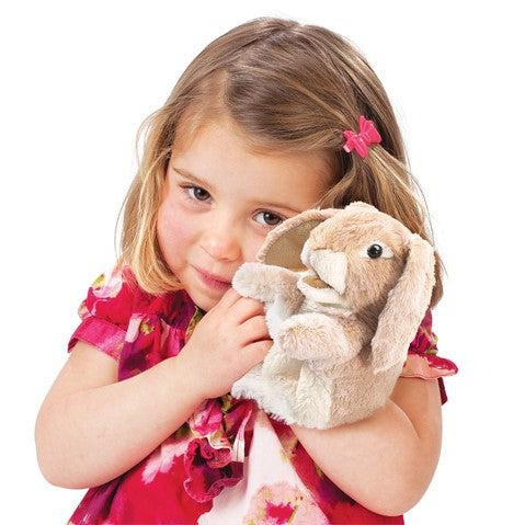 Beighe and white bunny puppet hugged by toddler