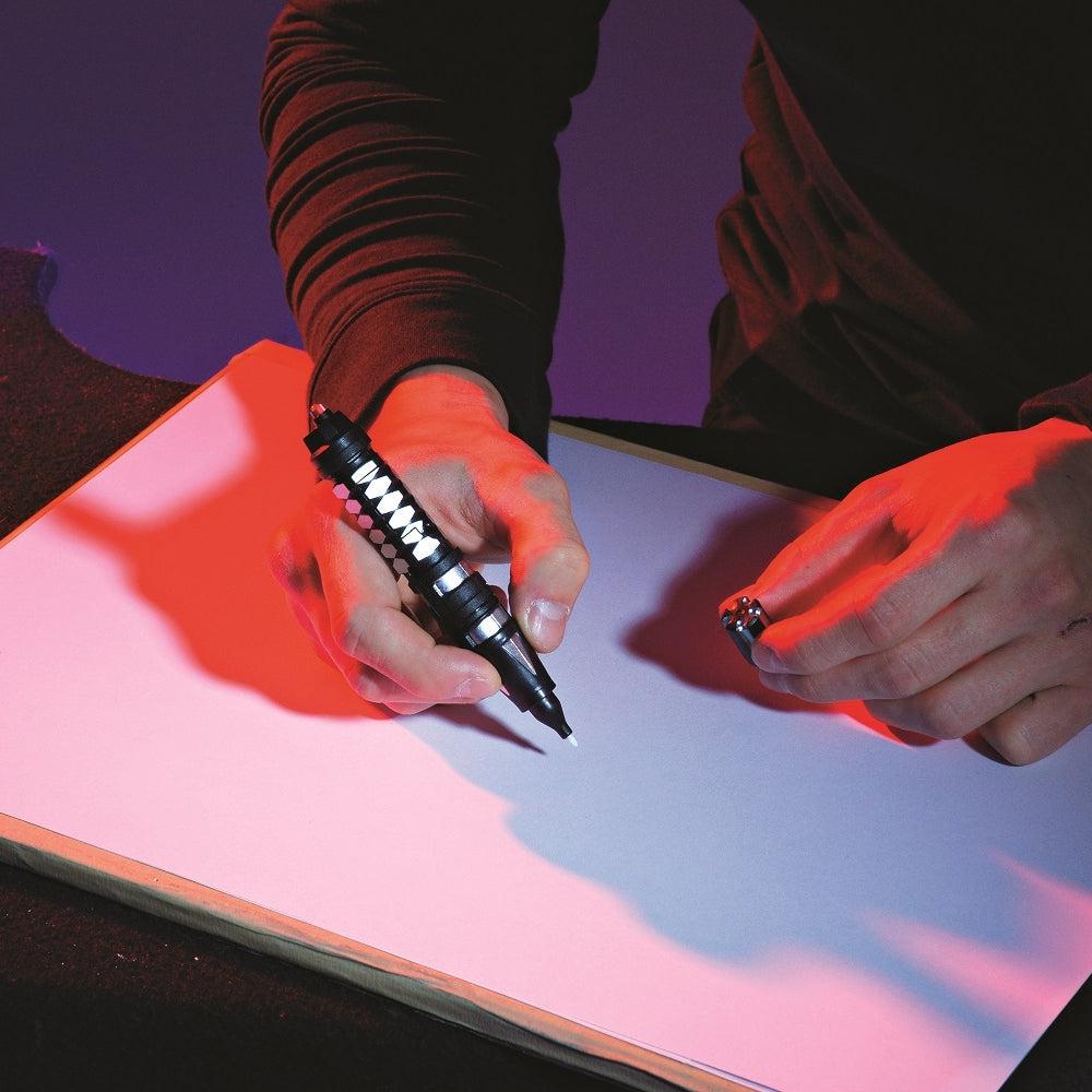 Front view of a person writing with the invisible ink pen.