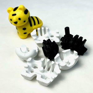 Front view of the yellow tiger put together and broken apart from the Puzzle Eraser-Safari set.