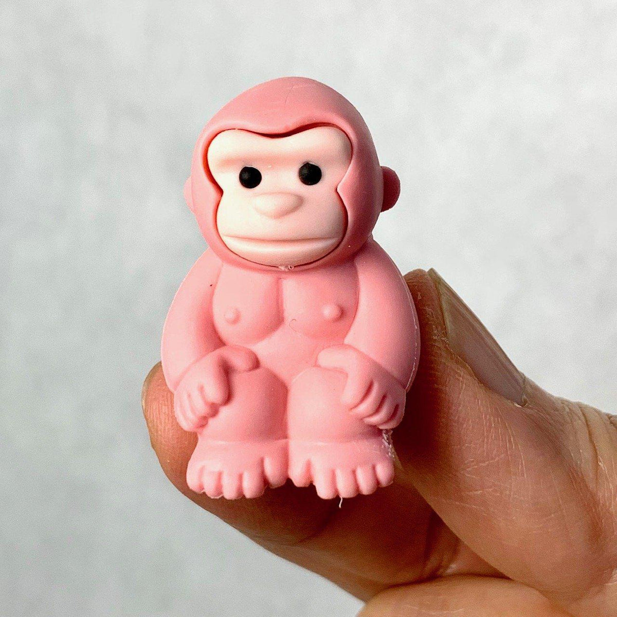 Front view of a pink gorilla being held in someone&#39;s fingers from the Puzzle Eraser-Safari set.