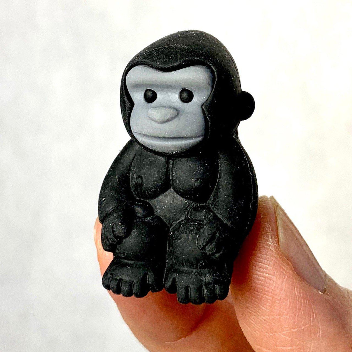 Front view of the black gorilla being held in someone&#39;s fingers from the Puzzle Eraser-Safari set.