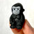 Front view of the black gorilla being held in someone's fingers from the Puzzle Eraser-Safari set.