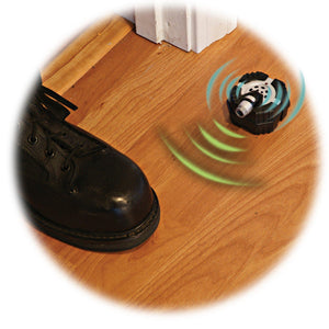 Side view of someone stepping in front of the motion alarm, with graphics showing sound coming from the alarm.