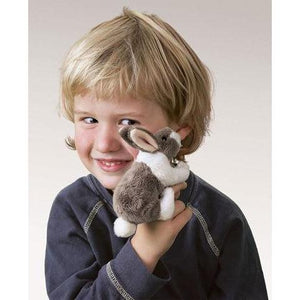 Child holding Mini Bunny on his finger and up to his face