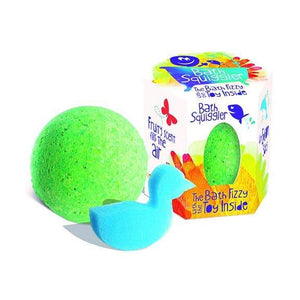 Front view of the green Bath Squiggler-Single Bath Bomb Surprise sitting beside with the package and the surprise beside it.